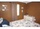 Bedroom featuring queen-sized bed and dresser with brown walls at 6249 Drucker Cir, Port Charlotte, FL 33981
