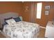 Bedroom featuring queen-sized bed and view of window with brown walls at 6249 Drucker Cir, Port Charlotte, FL 33981