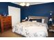 Bedroom featuring queen-sized bed and dresser with blue walls and tile flooring at 6249 Drucker Cir, Port Charlotte, FL 33981