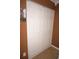A closet with white doors and square paneling on brown walls with a picture at 6249 Drucker Cir, Port Charlotte, FL 33981