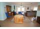 Inviting dining area with a round wooden table, blue chairs, and views into the kitchen area at 6249 Drucker Cir, Port Charlotte, FL 33981