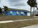 Inviting single-story home with a blue exterior, solar panels, and a convenient attached garage at 6249 Drucker Cir, Port Charlotte, FL 33981