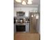 Close-up of a kitchen featuring modern appliances, white cabinets, and tiled backsplash at 6249 Drucker Cir, Port Charlotte, FL 33981