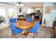 Bright kitchen with white cabinets, stainless steel appliances, and a dining area with blue chairs at 6249 Drucker Cir, Port Charlotte, FL 33981