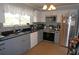 Bright kitchen featuring stainless steel appliances, white cabinets, and sleek countertops at 6249 Drucker Cir, Port Charlotte, FL 33981