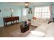 Comfortable living room featuring tile flooring, a white sofa, and stylish decor for a welcoming atmosphere at 6249 Drucker Cir, Port Charlotte, FL 33981