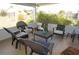 Covered patio featuring comfortable seating and views of the well-maintained backyard at 6249 Drucker Cir, Port Charlotte, FL 33981