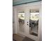 Glass patio doors looking out onto a furnished patio with decorative curtains at 6249 Drucker Cir, Port Charlotte, FL 33981