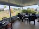 Charming screened-in patio furnished with outdoor seating and views of the garden at 6249 Drucker Cir, Port Charlotte, FL 33981