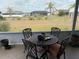 View of the backyard featuring a patio set for four with palm tree accents at 6249 Drucker Cir, Port Charlotte, FL 33981