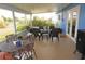 Covered patio with seating and a view of the landscaped backyard at 6249 Drucker Cir, Port Charlotte, FL 33981
