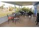 Inviting covered patio with stylish outdoor furniture and a view of the expansive backyard at 6249 Drucker Cir, Port Charlotte, FL 33981