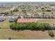 Expansive aerial view of the community with lush landscaping and well-maintained homes under a clear blue sky at 7196 N Plum Tree # 323, Punta Gorda, FL 33955