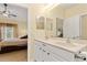 Well-lit bathroom featuring a double sink vanity and views into the bedroom at 7196 N Plum Tree # 323, Punta Gorda, FL 33955