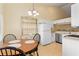 Charming dining area with an antique hutch, a modern chandelier, and ample natural light at 7196 N Plum Tree # 323, Punta Gorda, FL 33955