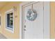 Charming condo entrance featuring a decorative wreath and a welcoming, well-lit doorway at 7196 N Plum Tree # 323, Punta Gorda, FL 33955