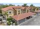 Charming condo building with a tile roof, private parking, and lush landscaping at 7196 N Plum Tree # 323, Punta Gorda, FL 33955