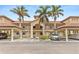 Inviting condo building with palm trees and covered parking spaces, perfect for coastal living at 7196 N Plum Tree # 323, Punta Gorda, FL 33955