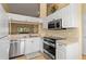 Modern kitchen showcasing stainless steel appliances, white cabinets, and sleek countertops at 7196 N Plum Tree # 323, Punta Gorda, FL 33955