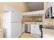 Well-lit kitchen featuring stainless steel dishwasher and white cabinetry at 7196 N Plum Tree # 323, Punta Gorda, FL 33955