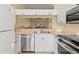 Well-equipped kitchen offering stainless steel appliances, white cabinets, and a functional design at 7196 N Plum Tree # 323, Punta Gorda, FL 33955