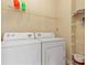 Bright laundry room equipped with a washer, dryer, and convenient shelving for storage at 7196 N Plum Tree # 323, Punta Gorda, FL 33955