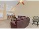 Inviting living room features a ceiling fan, plush seating, and seamless flow to the kitchen at 7196 N Plum Tree # 323, Punta Gorda, FL 33955