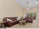 Spacious living room with comfortable seating, a ceiling fan, and balcony access at 7196 N Plum Tree # 323, Punta Gorda, FL 33955