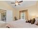 Bright bedroom with a ceiling fan and sliding glass doors to the lanai at 7196 N Plum Tree # 323, Punta Gorda, FL 33955