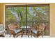 Screened patio featuring comfortable seating and a serene view of lush tropical landscaping at 7196 N Plum Tree # 323, Punta Gorda, FL 33955