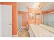 Spacious bathroom featuring double sinks, a large mirror, and a glass-door shower at 724 Blackburn Blvd, North Port, FL 34287