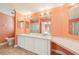 Bathroom featuring double sinks, a large mirror and a shower with glass doors at 724 Blackburn Blvd, North Port, FL 34287