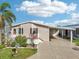 Inviting home exterior featuring well-manicured lawn and covered parking at 724 Blackburn Blvd, North Port, FL 34287