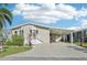 Inviting home with covered parking, front porch, and well-maintained landscaping at 724 Blackburn Blvd, North Port, FL 34287