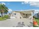 Inviting home with covered parking, front porch, and well-maintained landscaping at 724 Blackburn Blvd, North Port, FL 34287