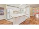 Well-lit kitchen features white appliances, kitchen island, tile flooring and plenty of cabinet space at 724 Blackburn Blvd, North Port, FL 34287