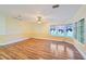 Bright living room with wood laminate flooring, ceiling fan and large windows offering ample natural light at 724 Blackburn Blvd, North Port, FL 34287