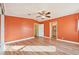 Bright main bedroom with wood laminate flooring, natural lighting, and a door to the main bathroom at 724 Blackburn Blvd, North Port, FL 34287