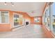 Bright sunroom featuring tile floors, a modern fireplace, and large windows offering plenty of natural light at 724 Blackburn Blvd, North Port, FL 34287