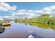 Still canal water with lush vegetation lining the sides, under blue skies at 724 Blackburn Blvd, North Port, FL 34287