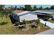 Aerial view of a well-kept home with white shutters and lush green landscaping at 861 Seabrooke Dr, Englewood, FL 34223