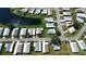 Aerial view of neighborhood homes surrounding a pond with mature trees and landscaping at 861 Seabrooke Dr, Englewood, FL 34223
