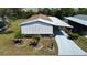 Aerial view of a well-kept home with white shutters and lush green landscaping at 861 Seabrooke Dr, Englewood, FL 34223