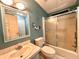 Cozy teal bathroom featuring a shower and bath combo with a frosted sliding glass door at 861 Seabrooke Dr, Englewood, FL 34223
