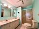 Bathroom with dual vanity, tiled floors, and walk-in shower at 861 Seabrooke Dr, Englewood, FL 34223