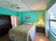 Bedroom features hardwood floors, ceiling fan, and large window for natural light at 861 Seabrooke Dr, Englewood, FL 34223