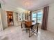Inviting dining room with large windows, built-in cabinet, and chandelier lighting at 861 Seabrooke Dr, Englewood, FL 34223