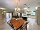 Combined dining and living area with bright lighting and views of the kitchen at 861 Seabrooke Dr, Englewood, FL 34223