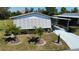 Cozy home featuring a carport, a driveway, decorative palm trees and privacy blinds for added comfort at 861 Seabrooke Dr, Englewood, FL 34223
