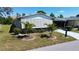 Charming home featuring mature landscaping with shutters for privacy and shade at 861 Seabrooke Dr, Englewood, FL 34223